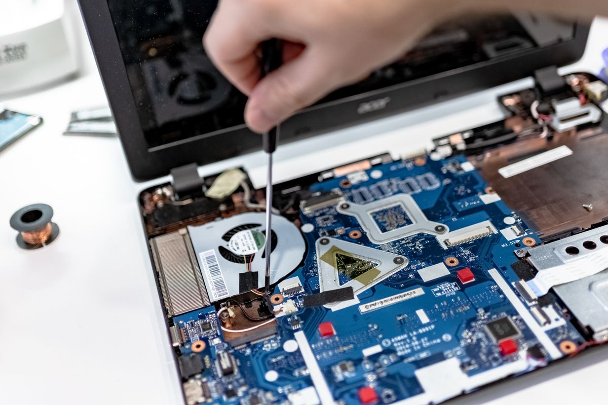 Hands-on laptop component repair with a screwdriver